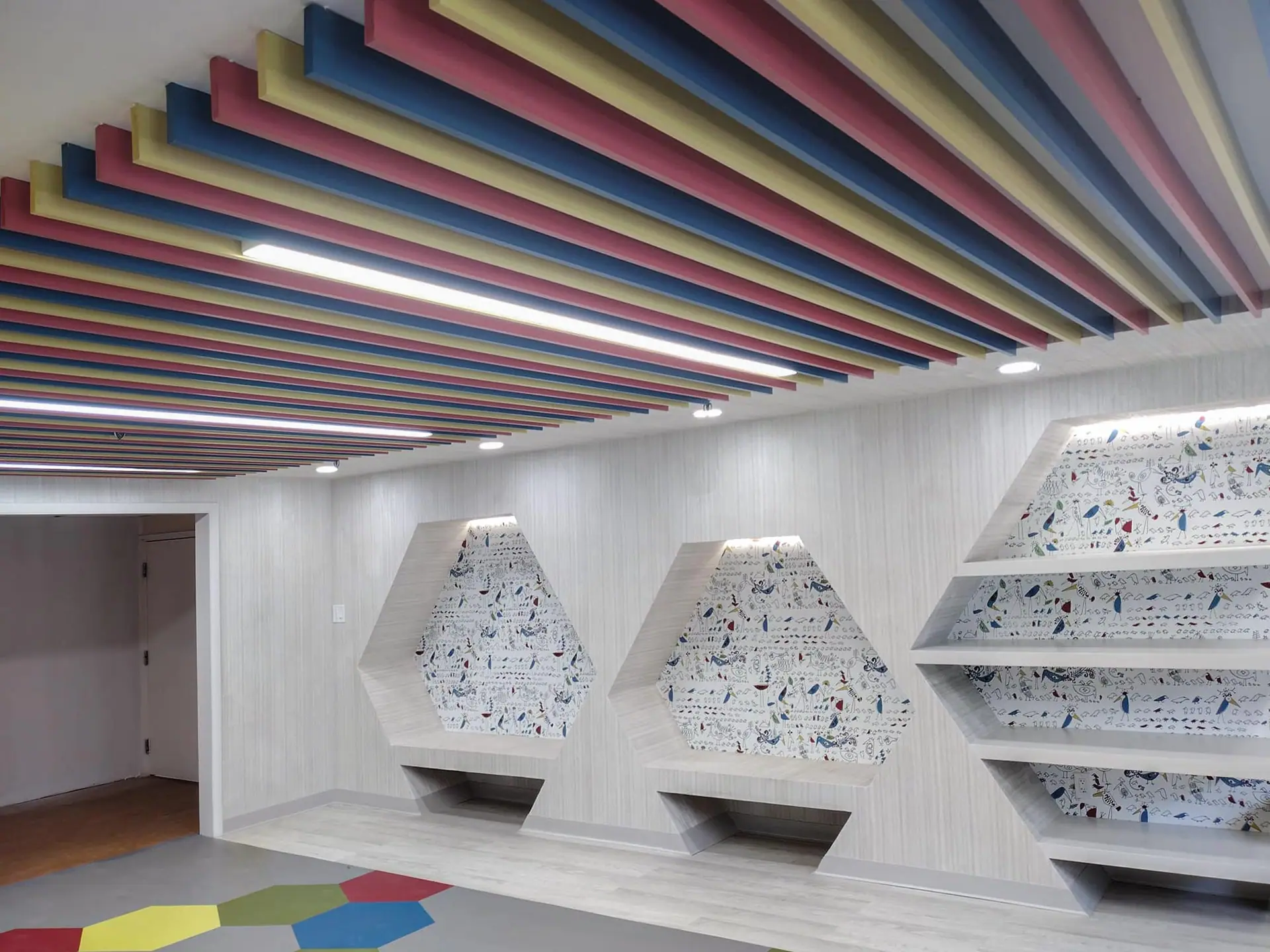 Painted slat ceiling in rainbow colors above built-ins